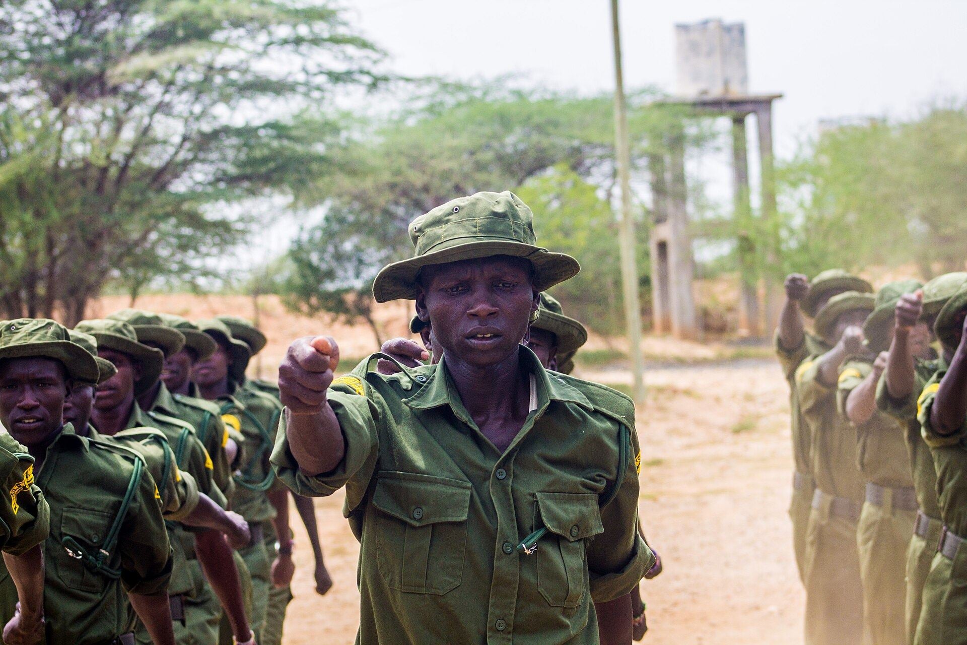 Uniformed conservancy rangers marching together during a training exercise in Kenya